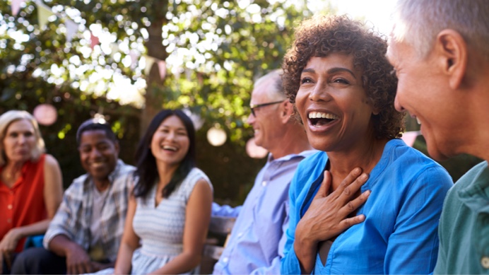 Happy middle-aged woman surrounded by friends