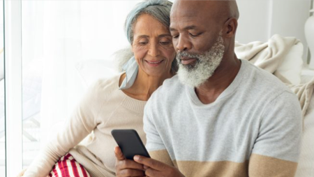 Middle-aged couple using a smartphone together