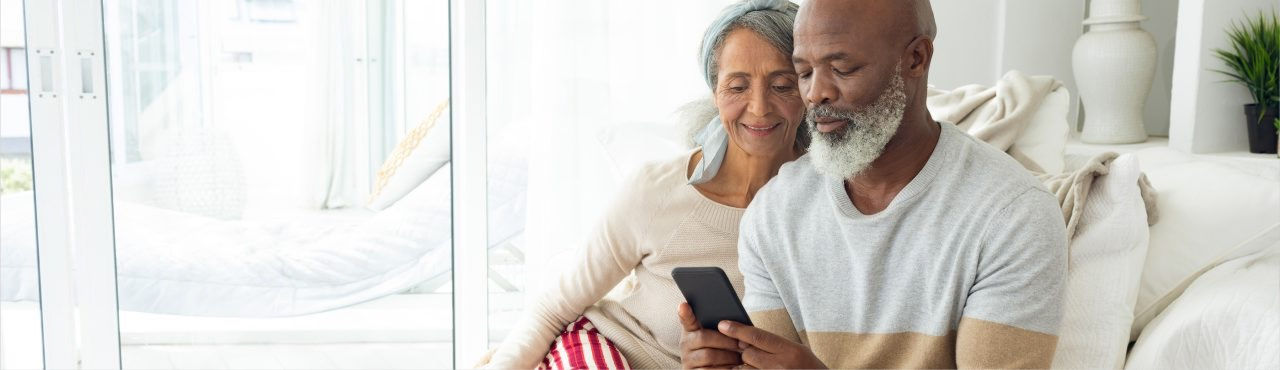 Hero banner showing middle-aged couple using a smartphone together