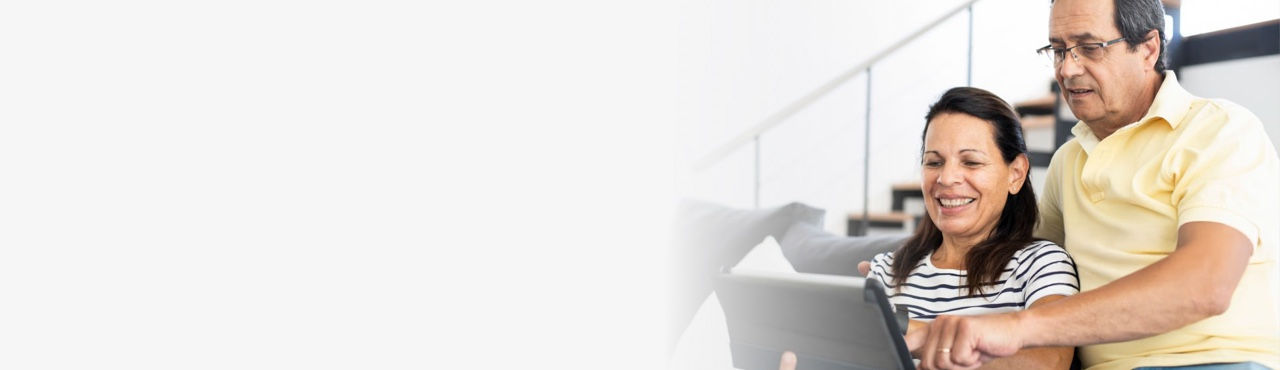 Hero banenr showing a middle-aged couple using a touchscreen tablet