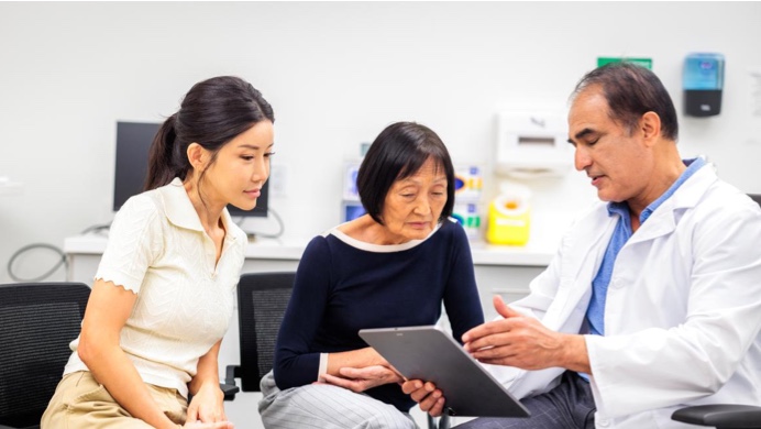 Mother and adult daughter consulting with healthcare provider