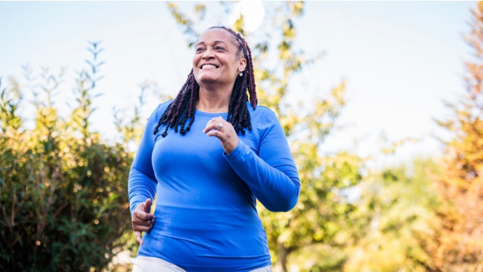Smiling older woman jogging