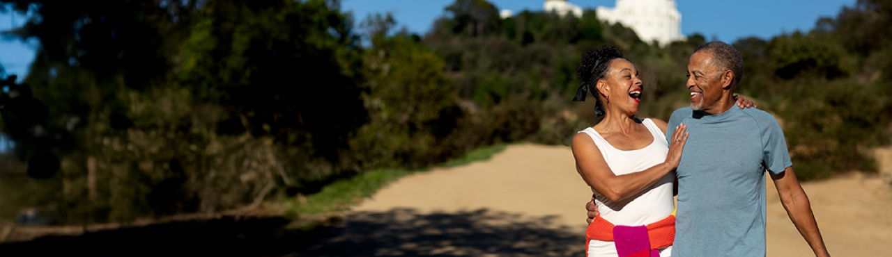 Teaser banner showing happy older couple walking on the beach