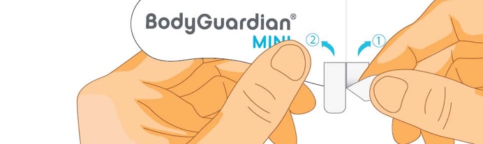 Close-up of fingers peeling the backing off of the ahesive strip