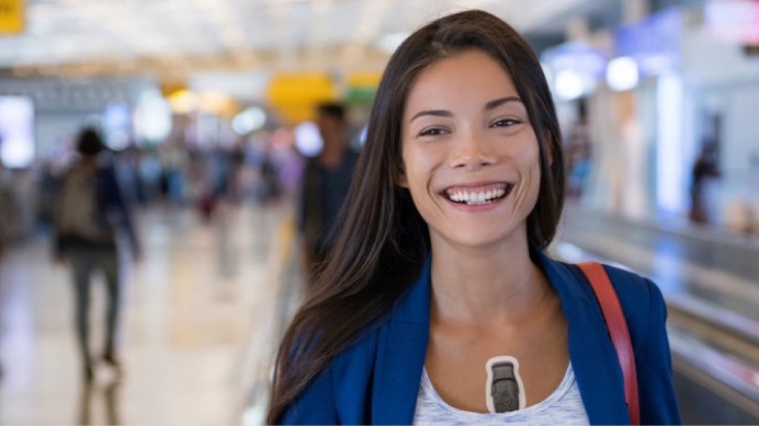 Smiling woman wearing BodyGuardain in  an airport